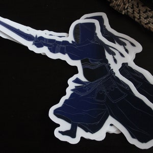 May include: A blue and white sticker of a person wearing a kendo uniform holding a shinai, a bamboo sword used in kendo.