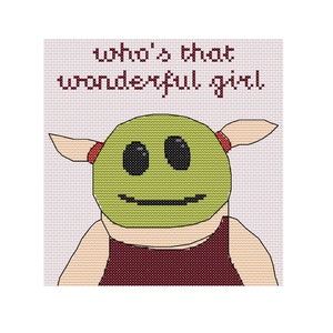 May include: Cross-stitch pattern featuring a green alien-like character with a red headband and the text "who's that wonderful girl".