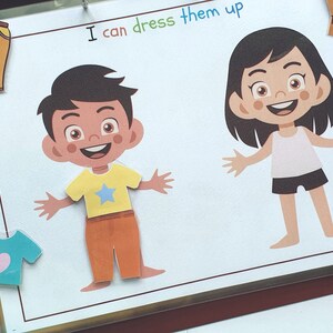May include: A printable activity sheet with two cartoon characters, a boy and a girl, with the text "I can dress them up".
