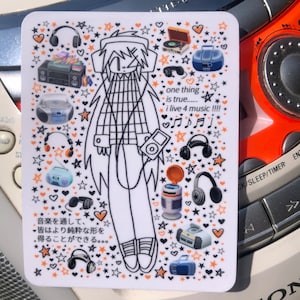 May include: A sticker featuring a cartoon character with a checkered shirt and headphones, surrounded by music-themed icons like cassette tapes, boomboxes, and stars. The text on the sticker reads "one thing is true... i live 4 music!!!" and "音楽を通して、皆はより純粋な形を得ることができる..."