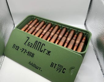 May include: A green ammunition box with a hinged lid, filled with copper-colored bullets. The box has black text on the front, including "7,62 ЛПС г.х." and "440шт."