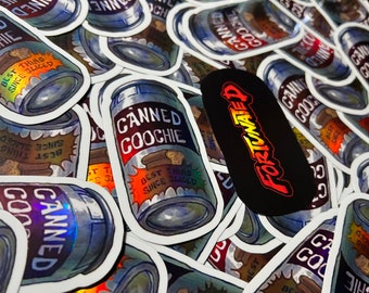 May include: A close-up of several holographic stickers featuring a can of "Canned Goochie" with the text "Best Thing Since Sliced" and a holographic finish. The stickers are arranged in a pile, with some overlapping.