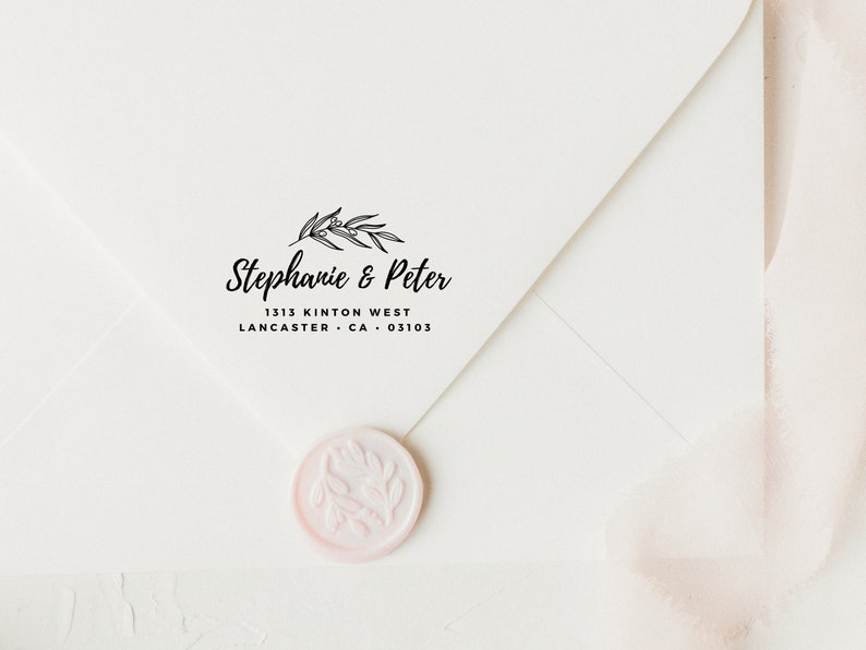 May include: A white envelope with a black return address stamp that reads "Stephanie & Peter 1313 Kinton West Lancaster, CA 03103". The stamp features a simple floral design. A pink wax seal with a floral design is on the envelope.
