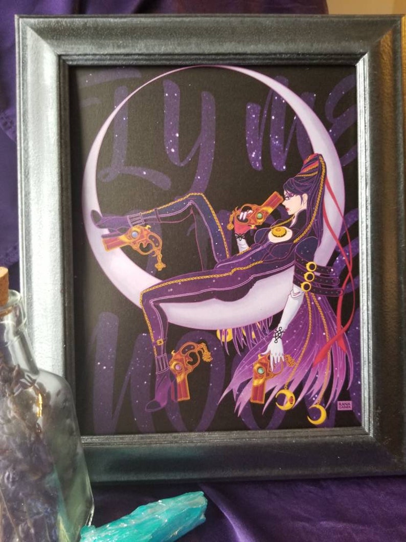 May include: A framed illustration of a woman in a black and purple outfit sitting on a crescent moon. The background is a dark purple with white stars. The text "Fly me to the moon" is written in white on the background.