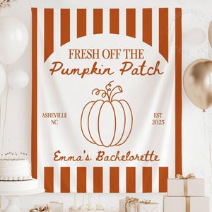 May include: A white banner with vertical orange stripes and the text "Fresh Off The Pumpkin Patch" in brown script. A brown pumpkin illustration is centered below the text. The banner also includes "Asheville NC" and "Emma's Bachelorette".