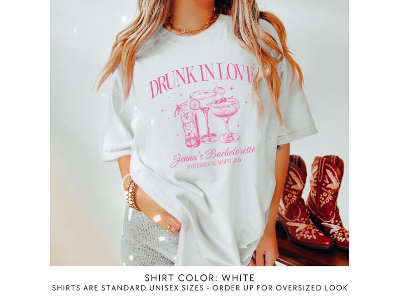 May include: White t-shirt with pink text that reads "Drunk in Love" and a graphic of two cocktails. The text below the graphic reads "Jenna's Bachelorette" and "Scottsdale, AZ August 2023".
