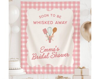 May include: A pink and white gingham backdrop with a scalloped edge, featuring the text "Soon to be whisked away" and "Emma's Bridal Shower." The design includes watercolor illustrations of kitchen utensils.
