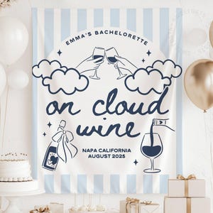 May include: A white and blue striped banner with the text "Emma's Bachelorette" and "on cloud wine". The design includes illustrations of wine glasses, clouds, and a wine bottle. Napa California, August 2025 is also printed on the banner.