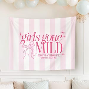 May include: Pink and white striped backdrop with the text "girls gone wild" in pink lettering. The text "Jenna's Bachelorette Asheville | August 2024" is also included in pink lettering.
