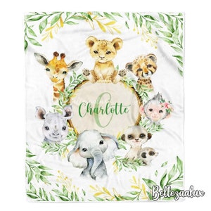 May include: A white baby blanket with a green leafy border and a circle in the centre with the name "Charlotte" in green text. The circle is surrounded by various animal illustrations, including a giraffe, lion, cheetah, monkey, rhino, elephant, and meerkat.
