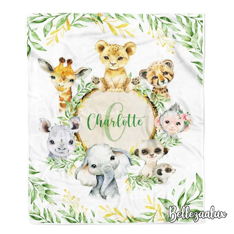 May include: A white baby blanket with a green leafy border and a circle in the centre with the name "Charlotte" in green text. The circle is surrounded by various animal illustrations, including a giraffe, lion, cheetah, monkey, rhino, elephant, and meerkat.
