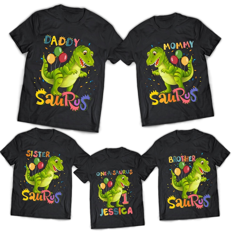 May include: Five black t-shirts featuring a dinosaur graphic and the words "Daddy", "Mommy", "Sister", "Brother", and "One-a-saurus Jessica" printed on them. The dinosaur is green and holding balloons.