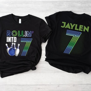 May include: Black t-shirts with a bowling theme. One shirt says "Rollin' into 7" with a bowling pin and ball graphic. The other shirt says "Jaylen" with a number 7 graphic.