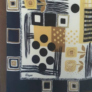 May include: A square silk scarf with a geometric pattern in black, white, and shades of brown and gold. The design includes squares, circles, and brushstroke-like lines. The brand name "Vizyon" is printed in the corner.