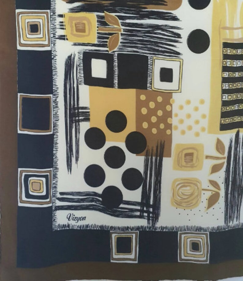 May include: A square silk scarf with a geometric pattern in black, white, and shades of brown and gold. The design includes squares, circles, and brushstroke-like lines. The brand name "Vizyon" is printed in the corner.