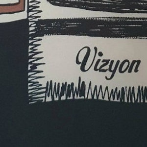 May include: Black and white graphic design with the word "Vizyon" in a cursive font. The design includes a black background, a white rectangular shape with the text, and a brown and white rectangular shape at the top.