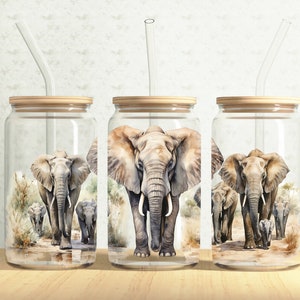 May include: Three glass jars with bamboo lids and clear drinking straws. Each jar has a watercolor illustration of elephants walking in a line. The elephants are gray with brown accents.
