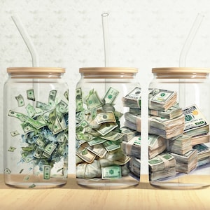May include: Three glass jars with wooden lids and clear drinking straws, each filled with stacks of US dollar bills. The bills are arranged in different ways, with some bills spilling out of the jars.