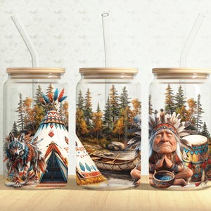 May include: Three glass jars with wooden lids and clear drinking straws. Each jar features a different scene with a Native American theme. One jar shows a wolf standing in front of a teepee, another shows a canoe in a forest, and the last jar shows a Native American man sitting with a drum.