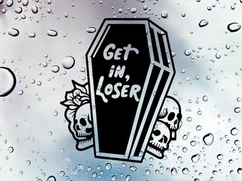 May include: Black and white sticker of a coffin with the text "Get in, Loser" on it. Three skulls are on either side of the coffin.