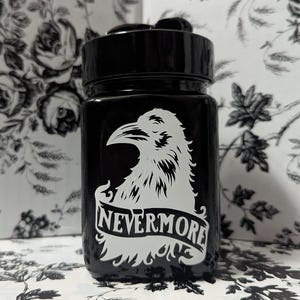 May include: Black glass jar with a white raven design and the text "Nevermore" on a banner.