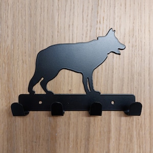 May include: Black metal dog silhouette wall hook with three hooks.