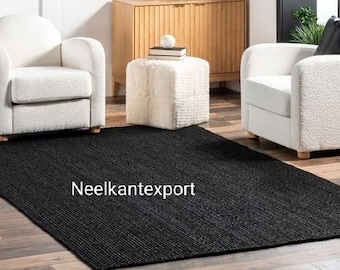 May include: A black and white striped rug with the text "Neelkantexport" in the center. The rug is placed in a living room setting with two white armchairs and a white ottoman.