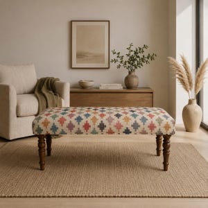 May include: A rectangular upholstered bench featuring a multi-colored geometric diamond pattern in shades of blue, red, yellow, and purple. The bench is supported by four dark brown turned wooden legs with a classic spindle design.