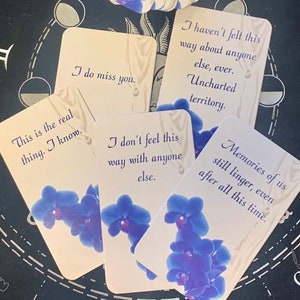 May include: A set of cards with blue orchid illustrations and text that reads "This is the real thing. I know.", "I do miss you.", "I don't feel this way with anyone else.", "I haven't felt this way about anyone else, ever. Uncharted territory.", and "Memories of us still linger, even after all this time."