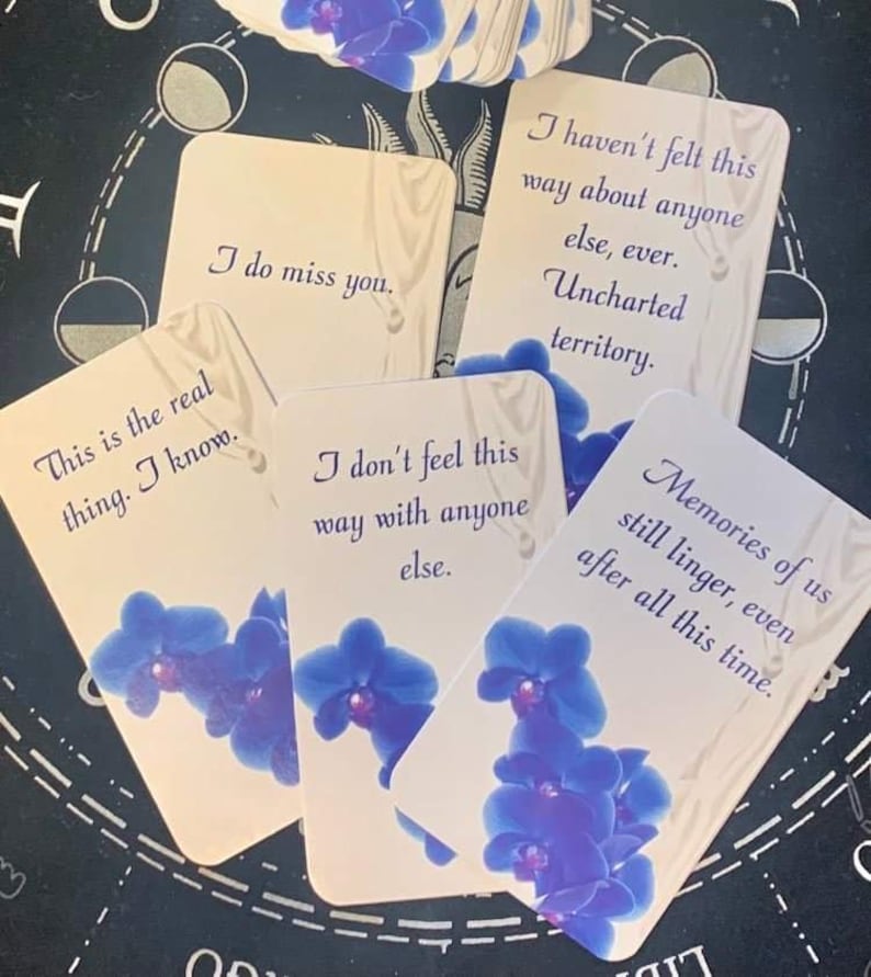 May include: A set of cards with blue orchid illustrations and text that reads "This is the real thing. I know.", "I do miss you.", "I don't feel this way with anyone else.", "I haven't felt this way about anyone else, ever. Uncharted territory.", and "Memories of us still linger, even after all this time."