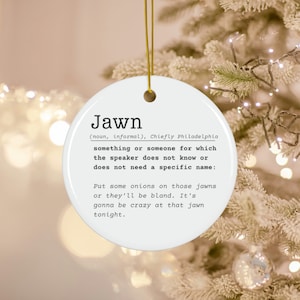 May include: White ceramic ornament with the word "Jawn" defined as "something or someone for which the speaker does not know or does not need a specific name." The definition continues with "Put some onions on those jawns or they'll be bland. It's gonna be crazy at that jawn tonight."