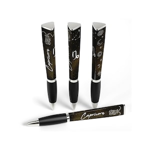 May include: Four black and silver pens with Capricorn zodiac designs. The pens have a triangular top with a silver cap and a black barrel. The pens are decorated with celestial patterns and the word "Capricorn".