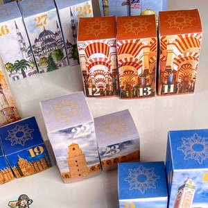 May include: A set of colorful, illustrated cardboard boxes with numbers 11, 12, 13, 14, 15, 16, 19, 21, 22, 23, 27, and 28. The boxes feature images of mosques and other Islamic architecture.