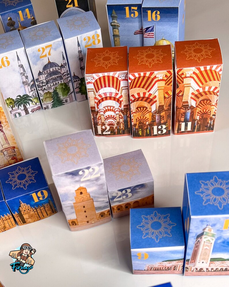 May include: A set of colorful, illustrated cardboard boxes with numbers 11, 12, 13, 14, 15, 16, 19, 21, 22, 23, 27, and 28. The boxes feature images of mosques and other Islamic architecture.