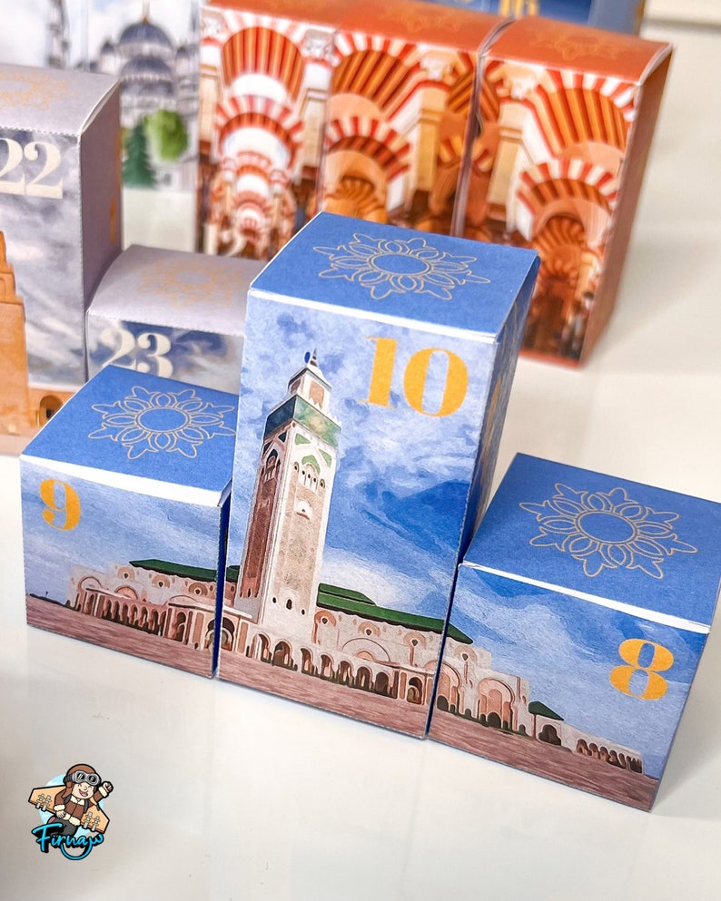 May include: A set of blue and gold cardboard boxes with numbers 8, 9, 10, 22, and 23. Each box features a different image of a mosque with a blue sky background.