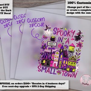 May include: A DTF decal sheet featuring a colorful Halloween-themed illustration with a small town, a ghost, a witch on a broomstick, and a cauldron. The text reads "SPOOKY IN A SMALL TOWN" with a customizable zip code box and purple floral accents.