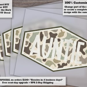 May include: Auntie decal with a camouflage pattern in shades of green, brown, and beige. The word "AUNTIE" is in white block letters. The image also includes text that says "100% Customizable!" and "Standard DTF, Glitter DTF, Glow in the Dark & UV DTF Decal."