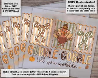May include: A sheet of decals featuring three rectangular frames with scalloped edges. The frames contain a brown polka-dot bow, a turkey wearing a pilgrim hat, and a green polka-dot bow. The text reads GOBBLE GOBBLE till you wobble with a pumpkin.