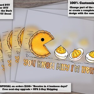 May include: A DTF decal featuring a yellow pie character resembling a video game icon chasing three deviled eggs on a light gray background. The text below the graphic reads, "YOU KNOW WHY I'M HERE" in a bold, orange-outlined font style.