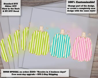May include: A set of three pumpkin decals featuring vertical stripes in lime green, turquoise, and pink. Each pumpkin has a light brown stem and a gold outline. The design is presented on a light gray background with text overlays describing the product.