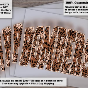 May include: A set of stacked transfer decals featuring the word BOMBERS in a block font. The letters have a brown and black leopard print pattern overlaid with small light-colored flower illustrations and a thin white outline border.