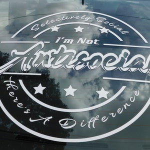 May include: White sticker on a car window with a black circle and the text "Selectively Social - I'm Not Antisocial There's A Difference" with five white stars.