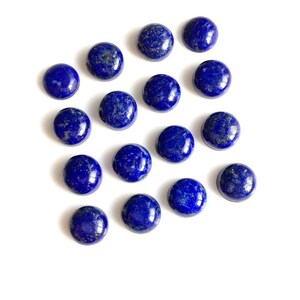 May include: A collection of 15 round, blue lapis lazuli cabochons. The cabochons are smooth and polished, with a deep blue color and some natural inclusions.