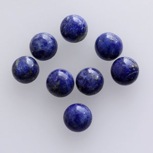 May include: Eight round, blue lapis lazuli cabochons with gold flecks. The cabochons are smooth and polished.