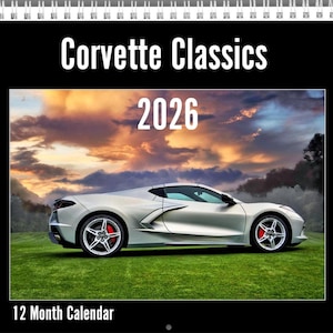 May include: A 12-month calendar featuring a silver Corvette sports car on a green lawn, set against a dramatic sunset. The calendar is titled "Corvette Classics 2026."