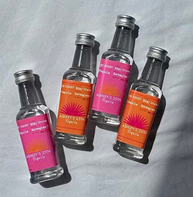 May include: Four clear glass bottles with pink and orange labels that say "Sunset Bday Cruise Tequila Norwegian" and "Ashley's 25th Tequila".