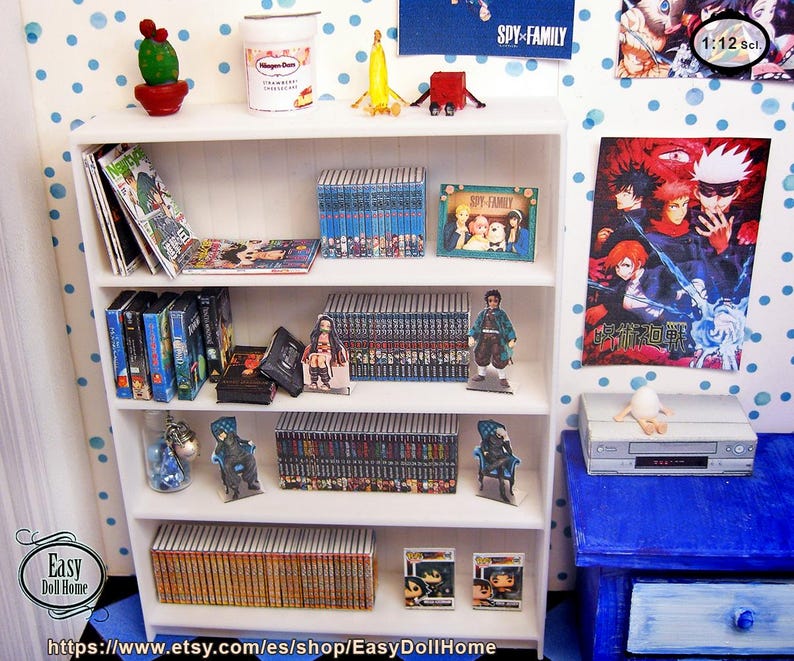 May include: A miniature white bookshelf filled with anime-themed books, DVDs, and figurines. The shelf also holds a small cactus, ice cream, and a poster that says "SPY x FAMILY".