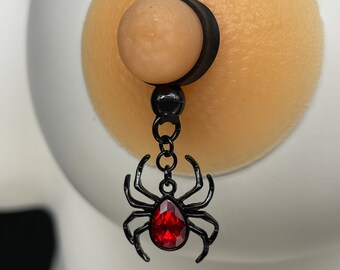 Black spider with red glass