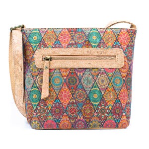 May include: A patterned crossbody bag with a diamond design. The bag has a cork zip pocket and strap, with a vibrant mix of teal, orange, red, and purple hues. The bag is rectangular and has a long adjustable strap.