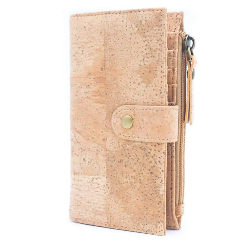 May include: A light brown cork wallet with a zippered pocket and a snap closure. The wallet has a textured cork surface and a gold-colored button.